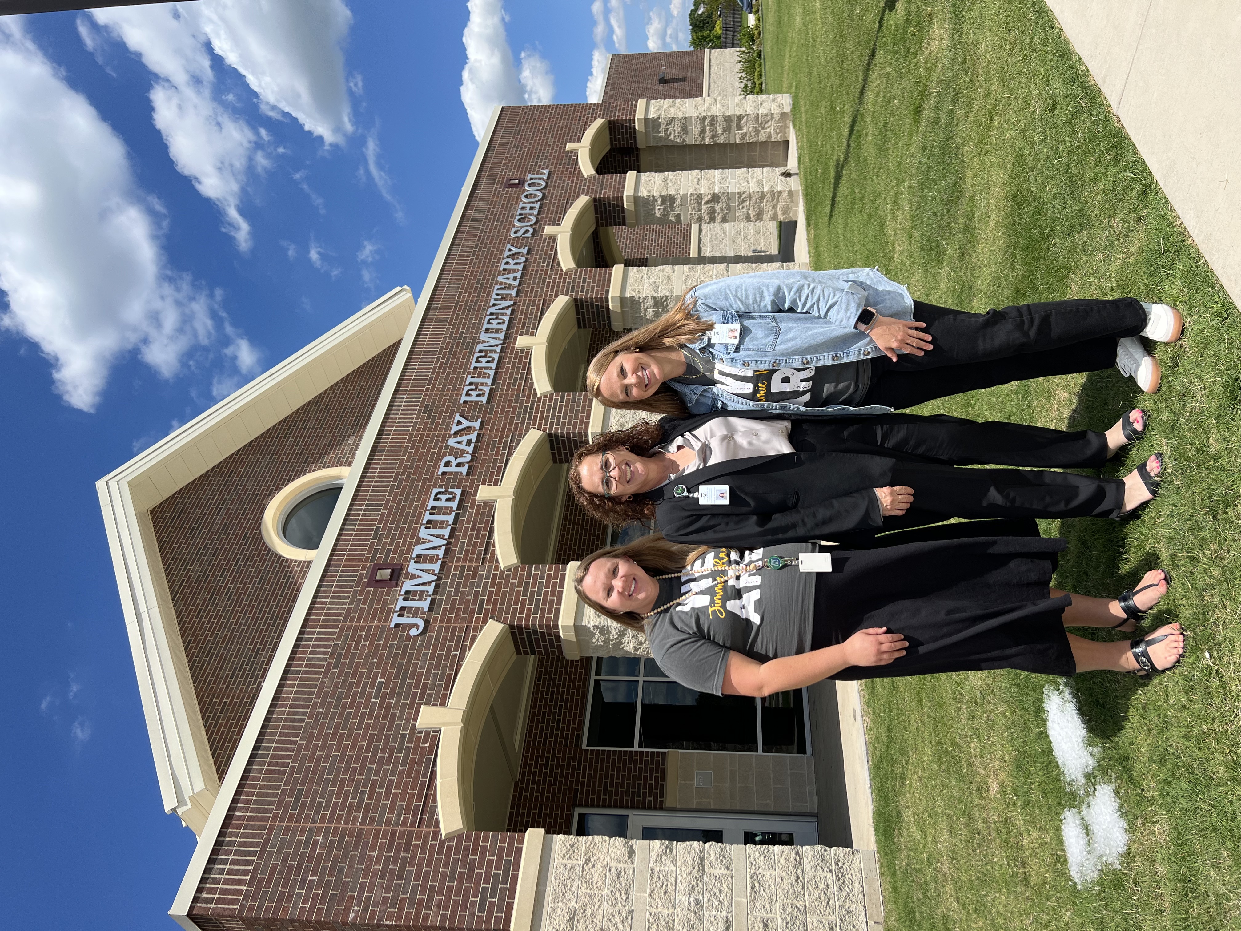 3 women in front of school